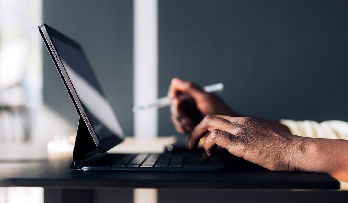 A business leader reading on a computer about how AI can make their company more efficient