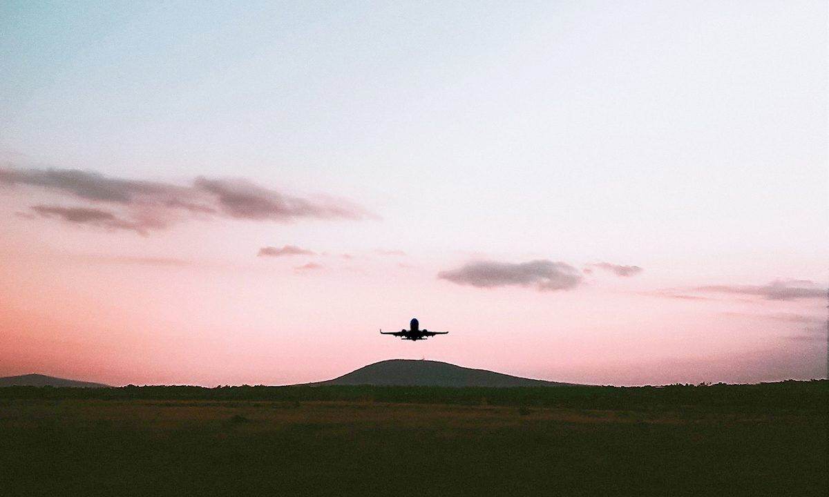 Photography or a plane that just took off in the middle of a large field.